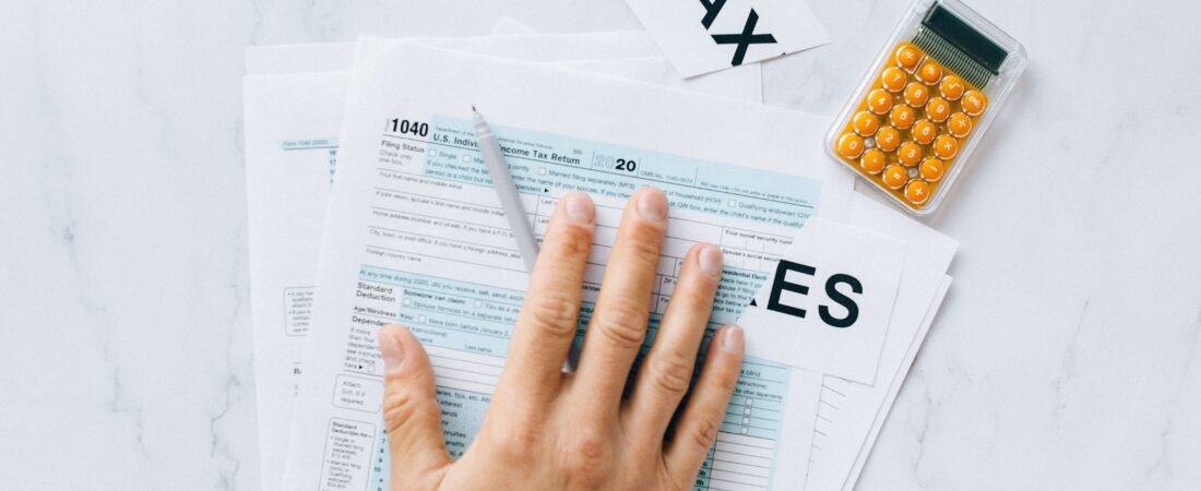 worried college student looking at laptop tax forms