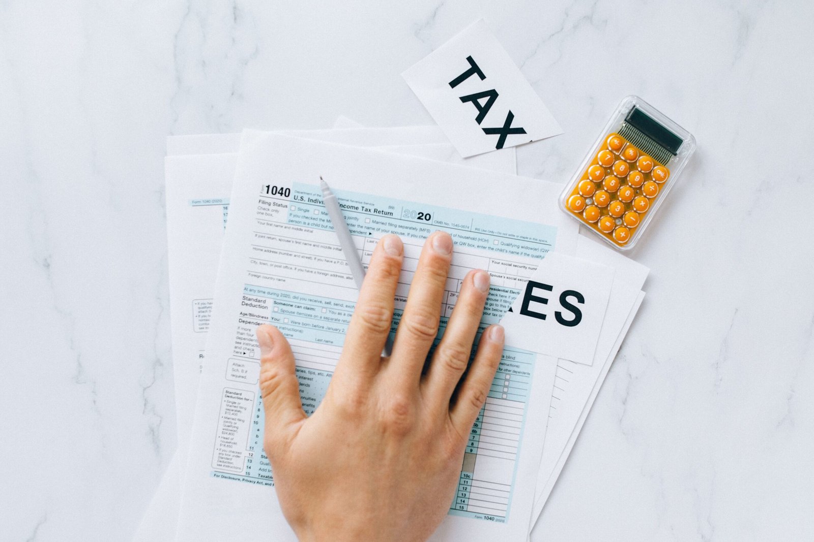 worried college student looking at laptop tax forms