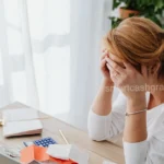 stressed college student staring at unexpected health insurance charges on school bill
