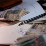 How Debt Consolidation Affects Credit Score: The Honest 2026 Guide A young adult reviewing a credit score graph on a laptop screen alongside financial budget charts