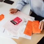 How to Cut Your Monthly Subscriptions and Save Big A young adult systematically auditing recurring monthly memberships and digital subscriptions on a laptop screen.