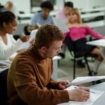 college student organizing colorful handwritten study notes