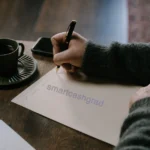 How to Appeal Financial Aid After a Parent Loses a Job (2026 Guide) A handwritten financial aid appeal letter on a desk next to an envelope and a college tuition bill