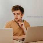 A college student working on a high-tech remote support setup with multiple monitors in a modern dorm room.