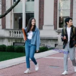 Best Bank Accounts for International Students in the US: The Ultimate Guide (+ Cash & Deposit Rules) An international student sitting at a U.S. bank branch reviewing checking account documents with a banker.