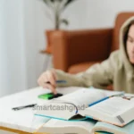 How to Apply for Financial Aid Reinstatement 2026: The Ultimate SAP Appeal Survival Blueprint A close-up shot of a student holding a pen, analyzing a document titled Financial Aid Suspension Warning next to an open laptop.